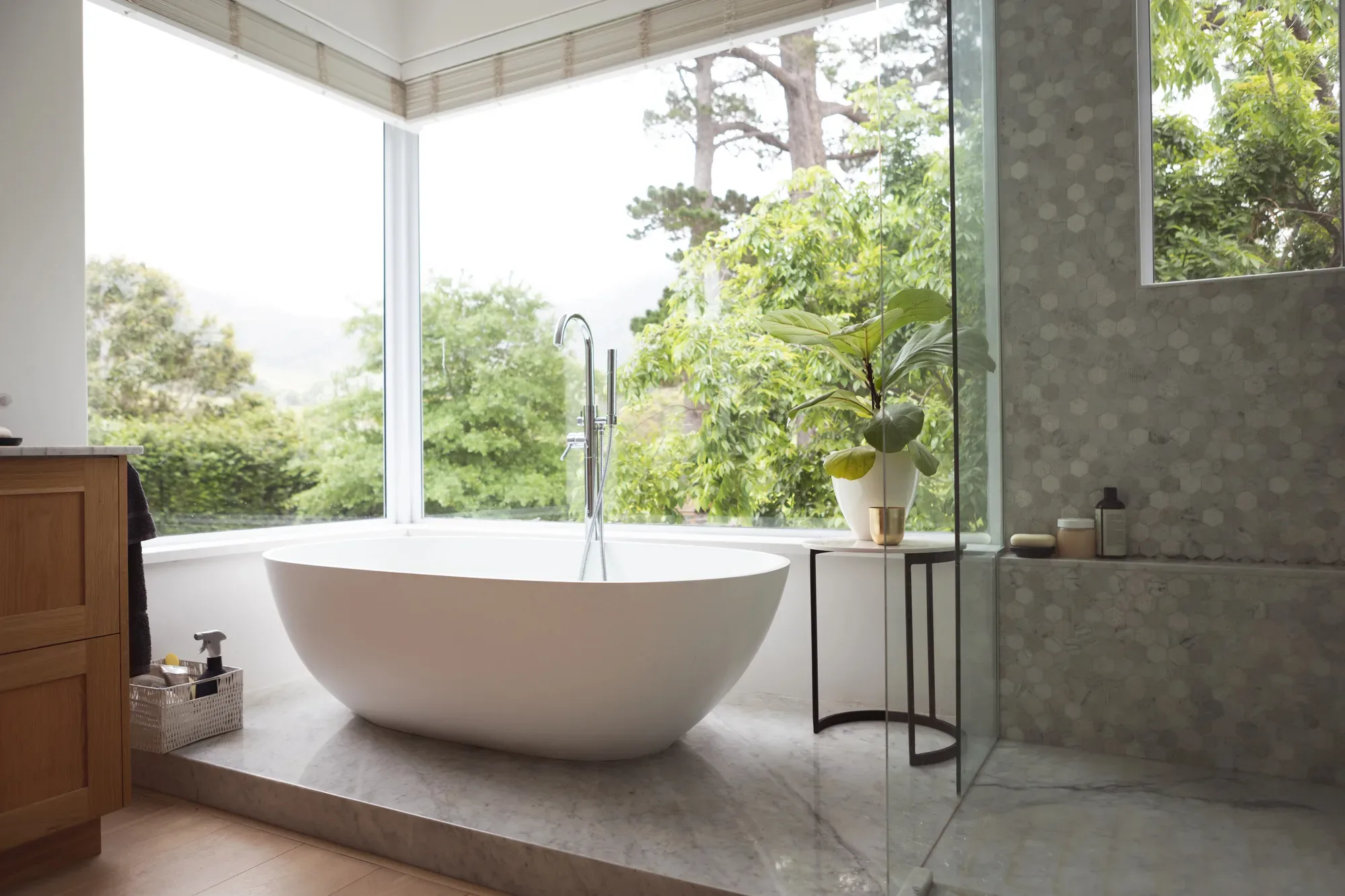 Luxury bathroom renovation with freestanding bath and garden outlook