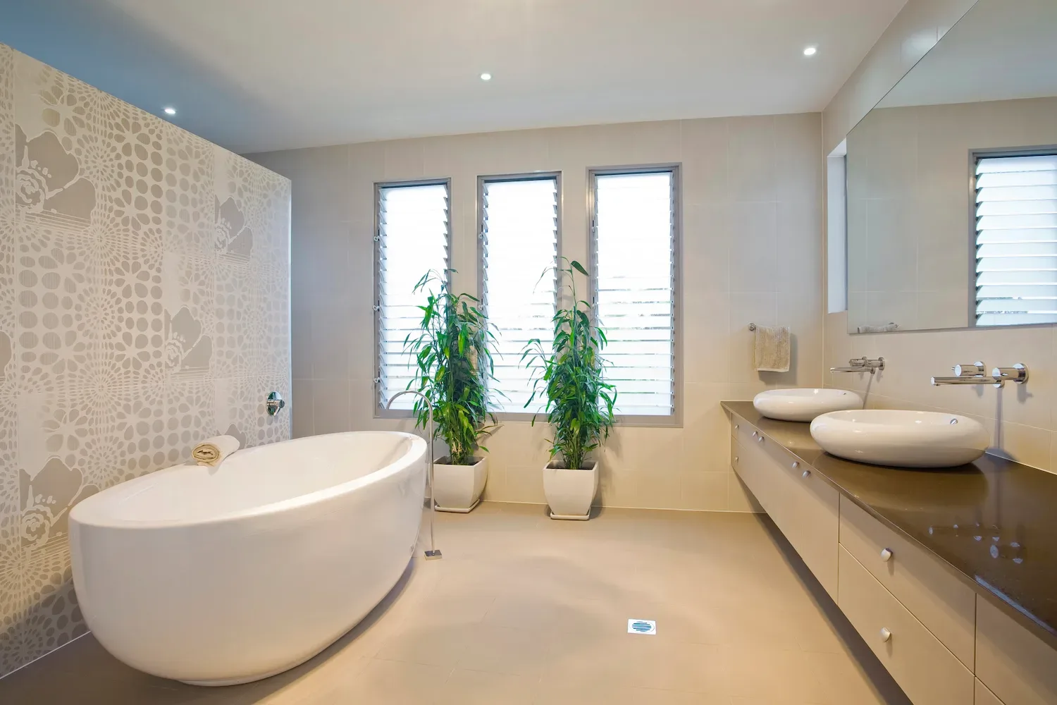 Freestanding bath against a patterned feature tile wall