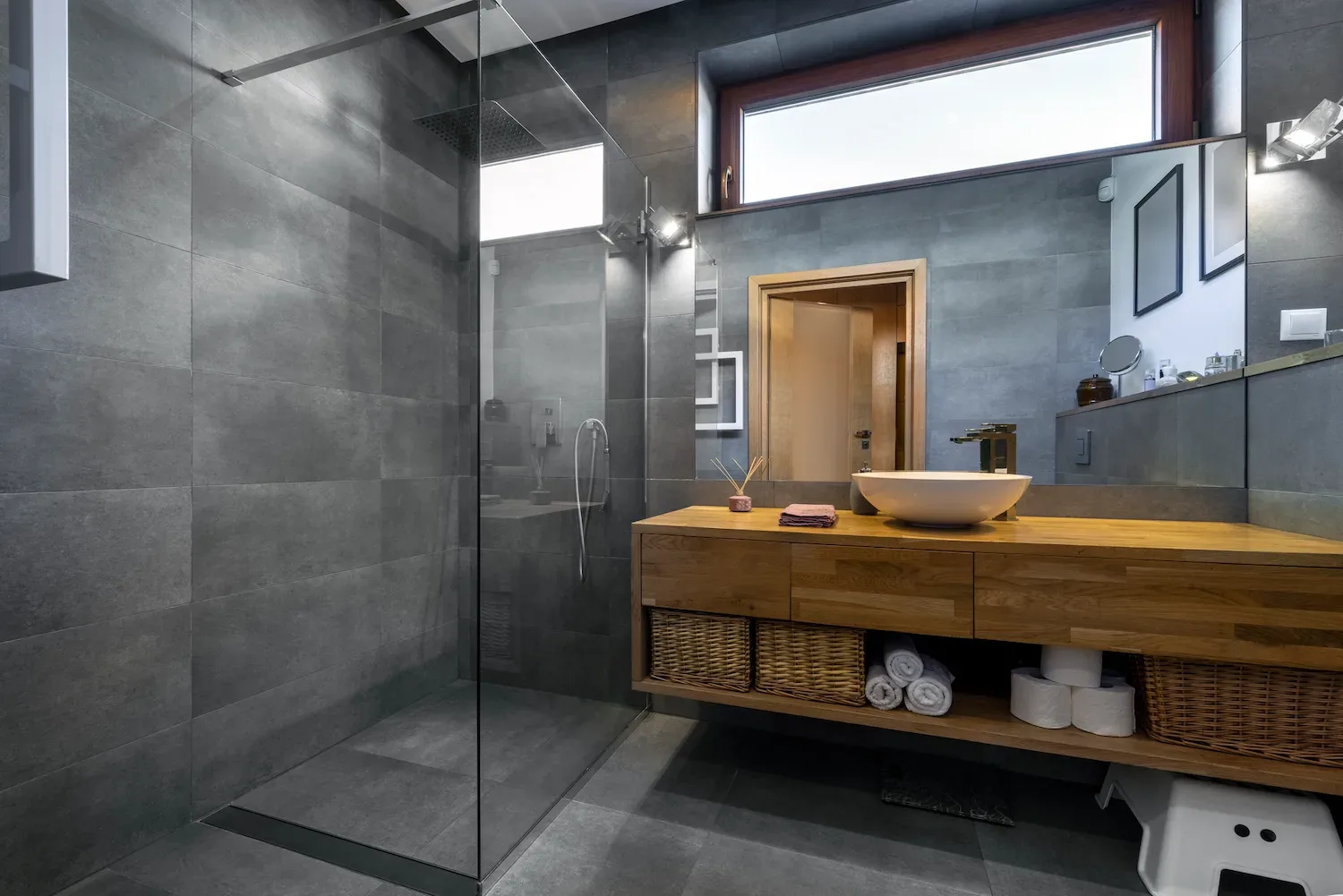 Finished grey-tiled bathroom with timber vanity and walk-in shower