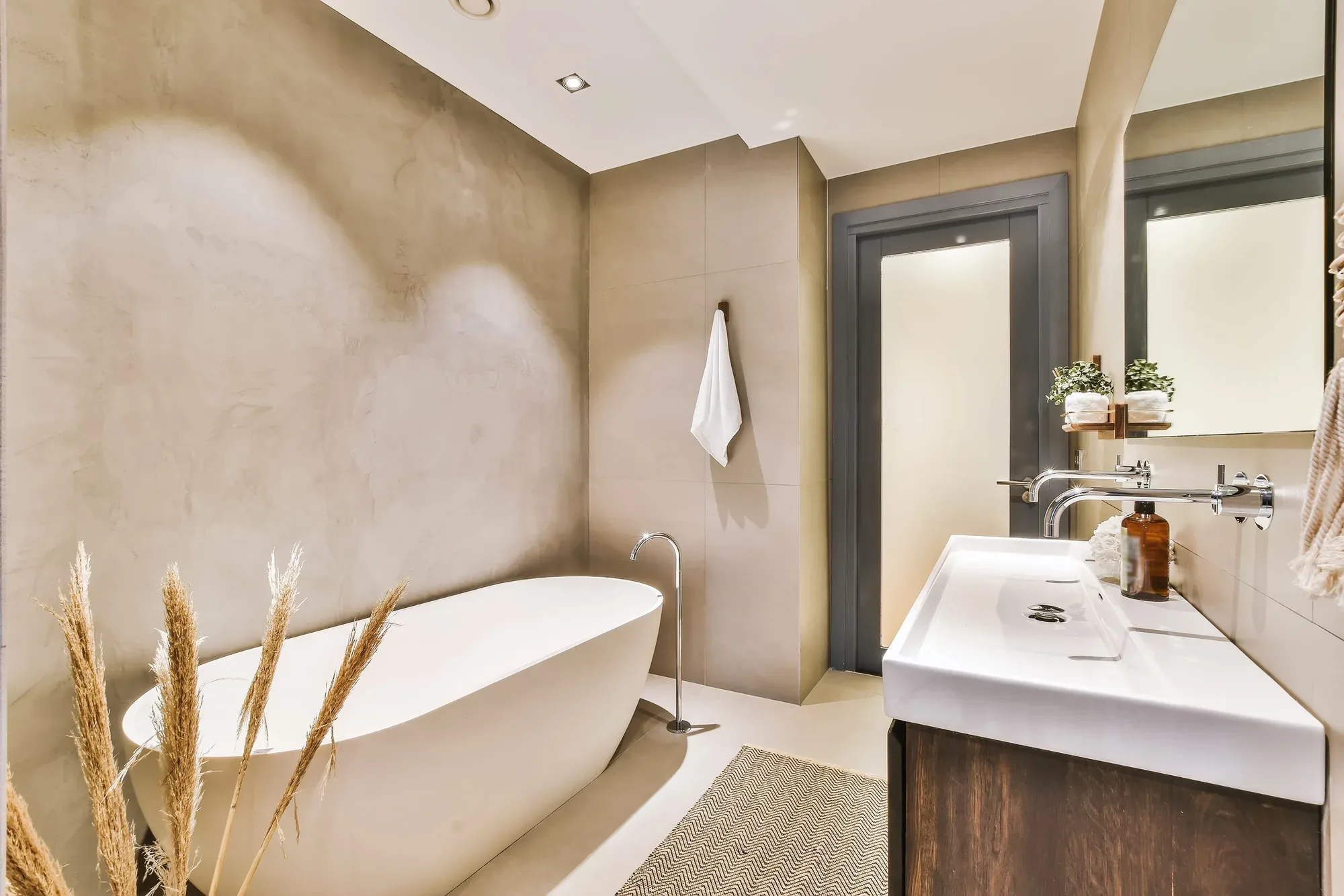 Full bathroom renovation with freestanding bath and stone tiling