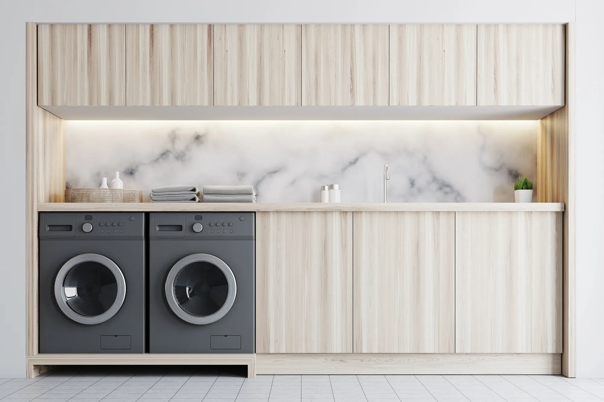 Renovated laundry with marble splashback and built-in cabinetry