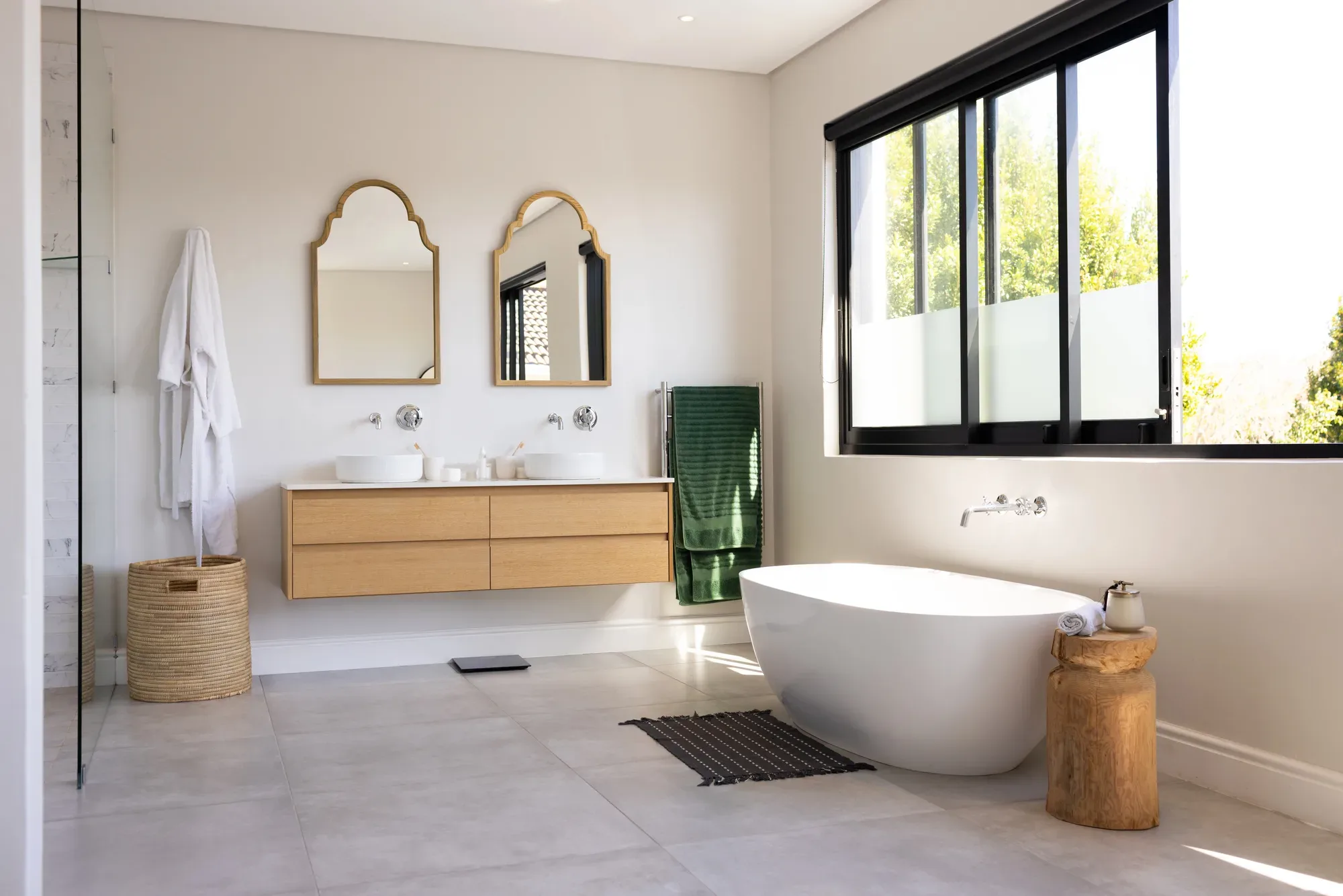 Spa-style luxury bathroom with stone tiling and freestanding bath
